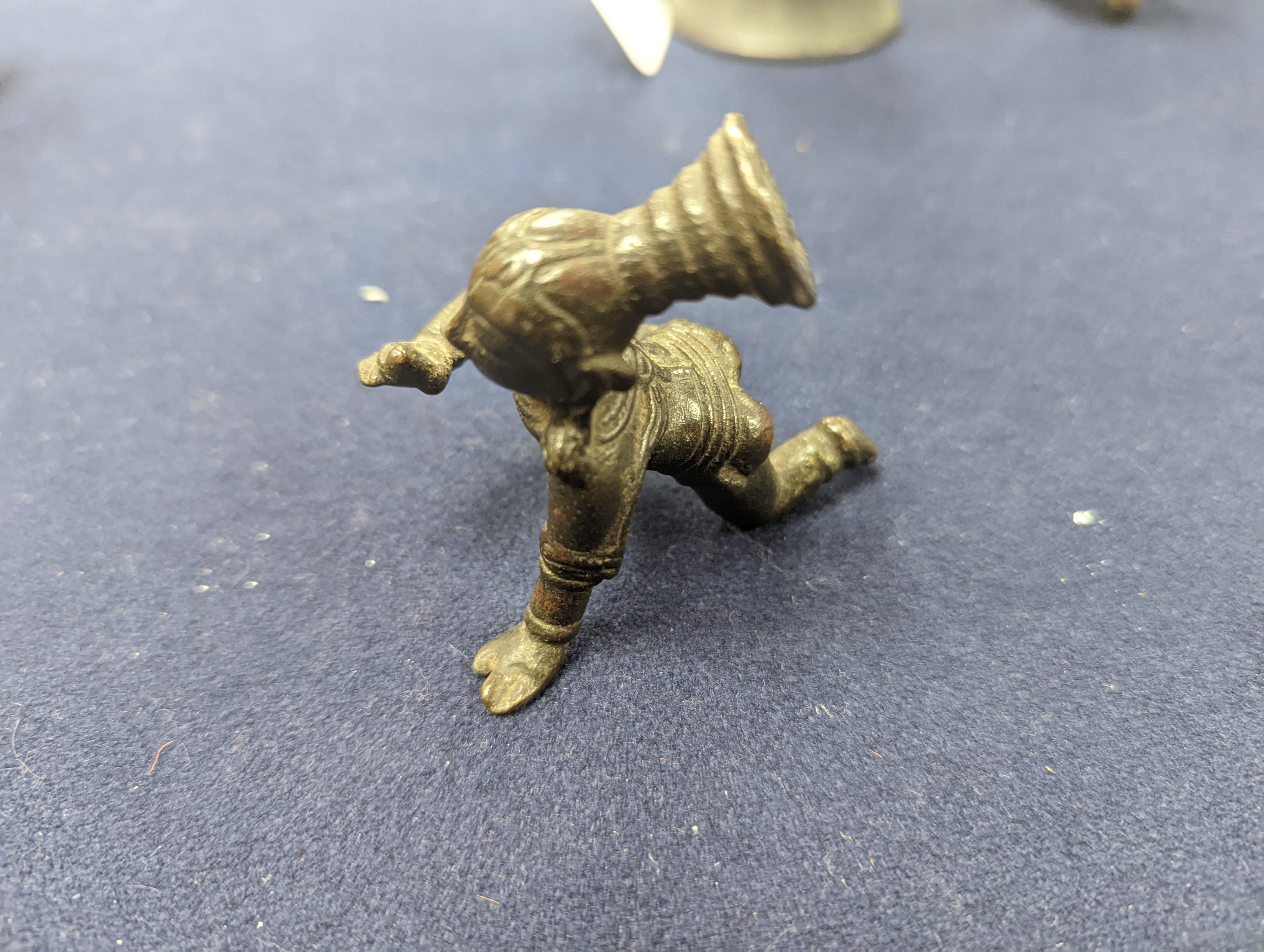 A Chinese gilt copper figure, a Chinese Dog of Fo, a bell, a censer, six Indian bronze figures and a scroll box